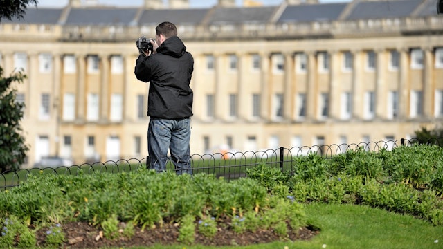 A man taking photographs at The Royal Crescent, Bath, APRIL 1, 2010.