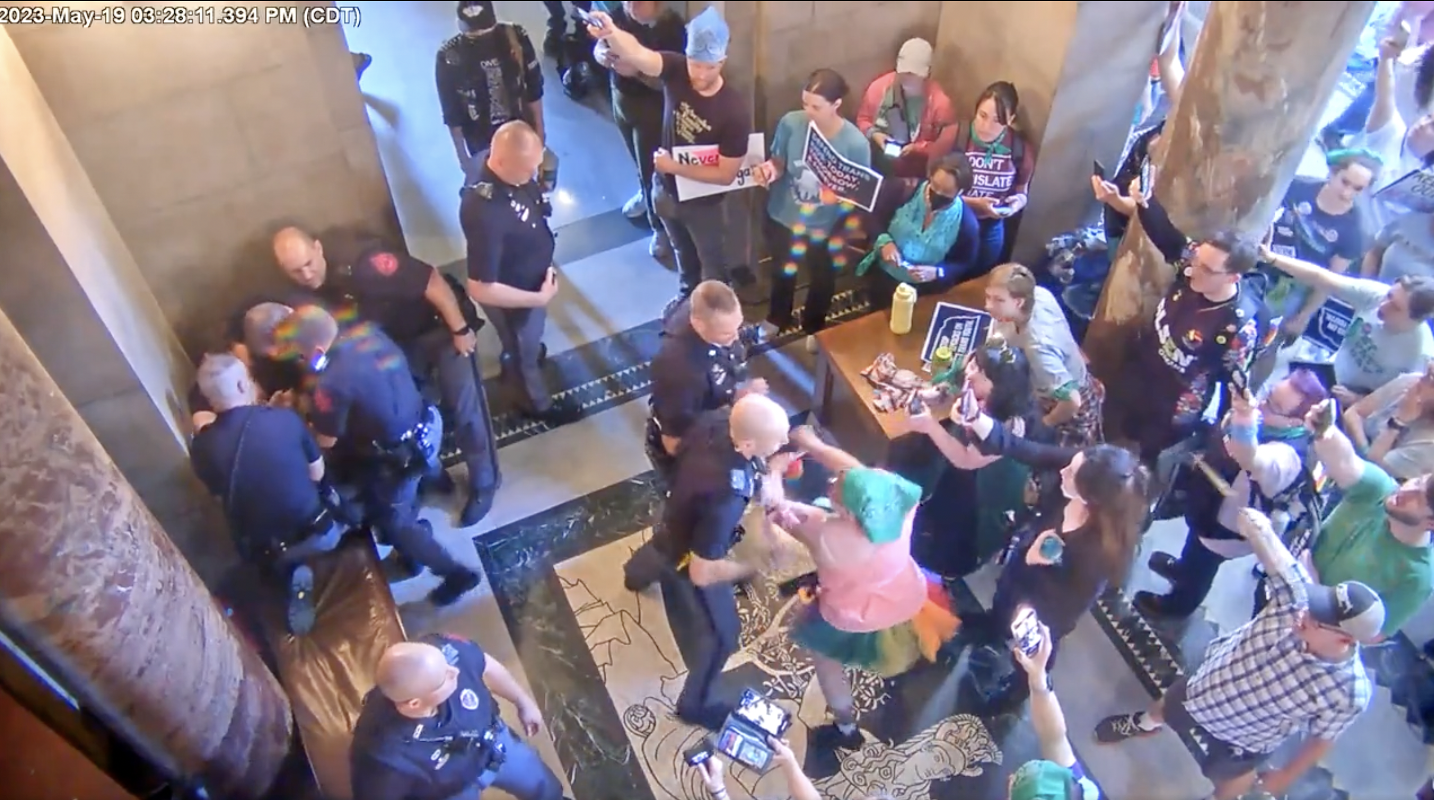 Protester attacks police officer during Republican vote to ban trans procedures on minors.