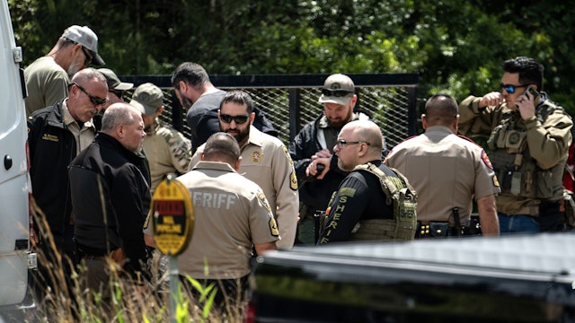 CLEVELAND, TX - APRIL 29: Law enforcement search for the suspect a few miles from the scene where five people, including an 8-year-old child, were killed after a shooting inside a home on April 29, 2023 in Cleveland, Texas. The alleged gunman, who is not yet in custody, used an AR-15-style rifle to shoot his neighbors which also left at least three others injured.