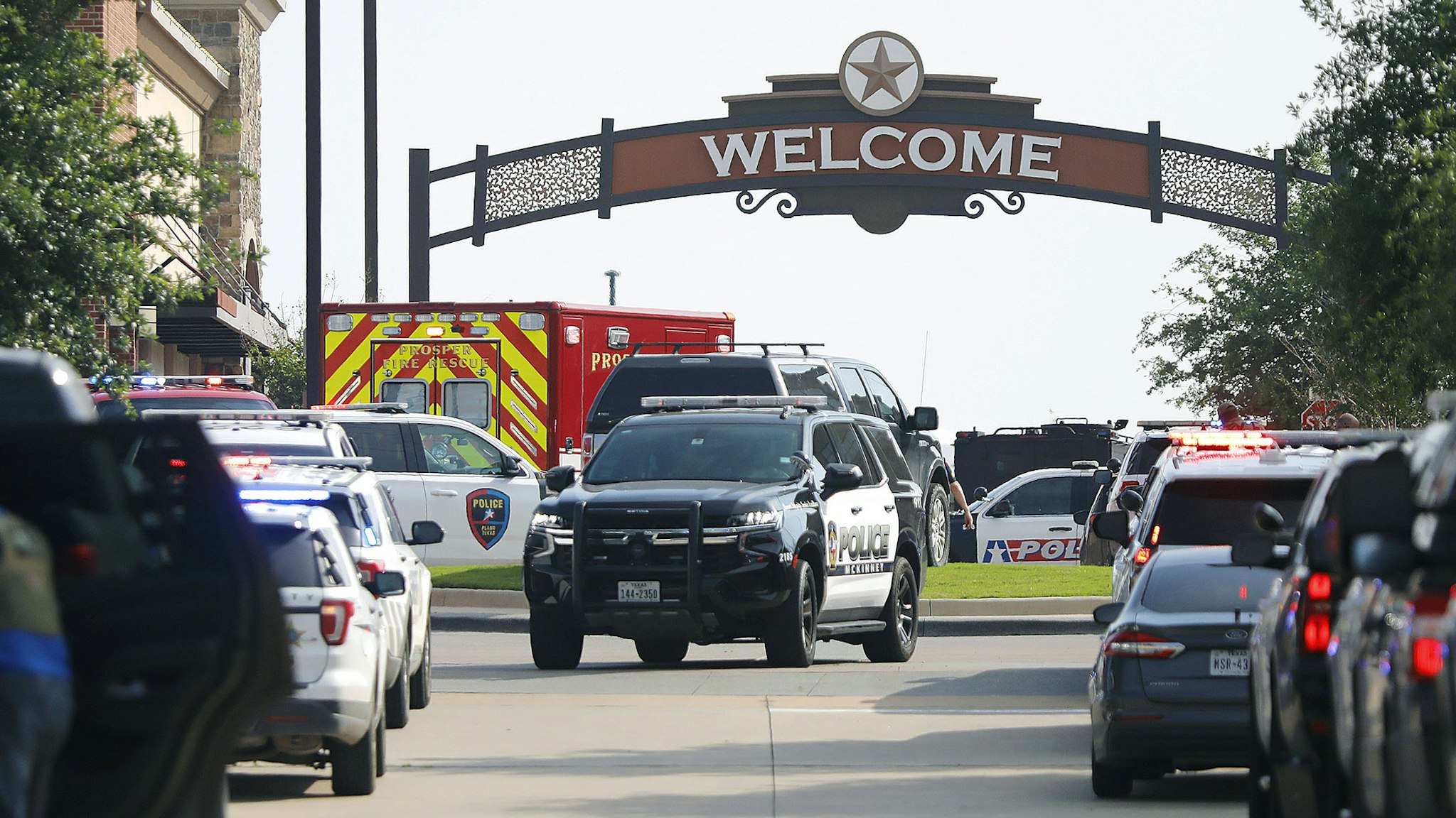 ALLEN, TEXAS - MAY 6: Emergency vehicles line the entrance to the Allen Premium Outlets where a shooting took place on May 6, 2023 in Allen, Texas. According to reports, a shooter opened fire at the outlet mall, injuring at least nine people who were taken to local hospitals. The police have confirmed there were fatalities but have not specified how many. The unidentified shooter was neutralized by an Allen Police officer responding to an unrelated call.