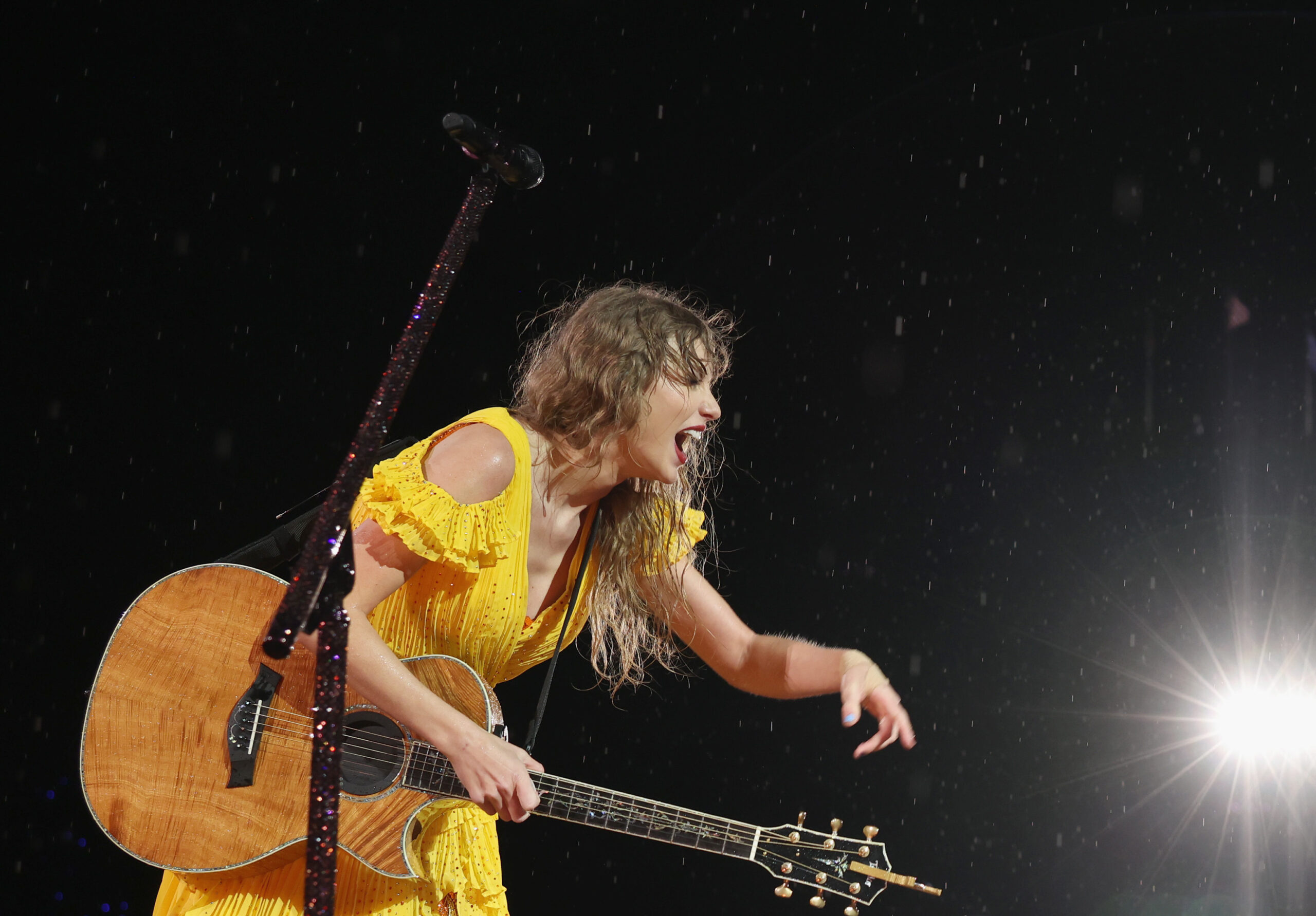 Taylor Swift performs in Nashville despite storm delay, braving pouring rain.