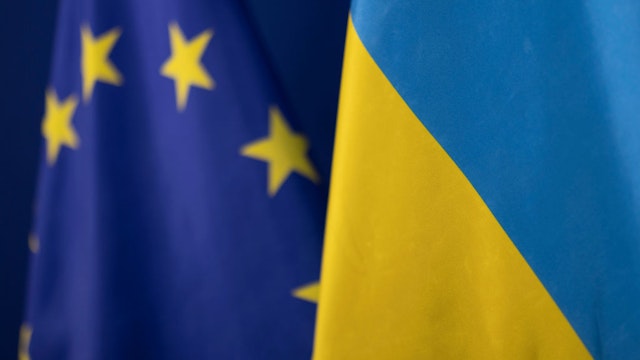 28 February 2023, North Rhine-Westphalia, Duesseldorf: The flag of Ukraine stands in front of the flag of the European Union. (Photo by Christoph Reichwein/picture alliance via Getty Images)