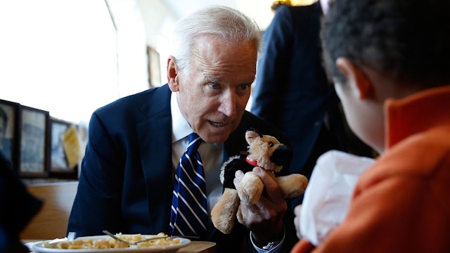 WASHINGTON, DC - MARCH 26: U.S. Vice President Joe Biden gives a young boy a stuffed version of Biden's dog, Champ, while visiting a diner March 26, 2014 in Washington, DC.