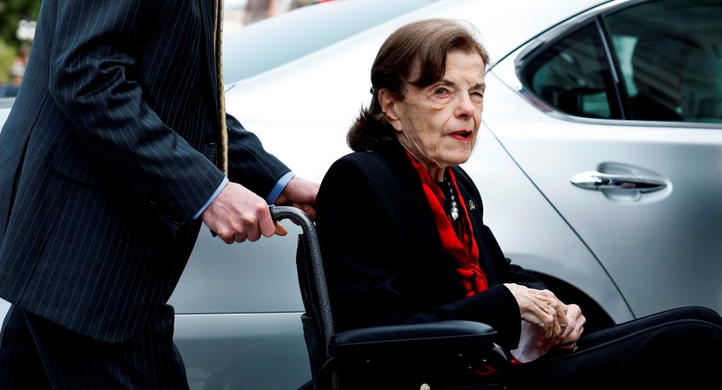 Feinstein’s team attempted to conceal her wheelchair and created a barrier to protect her from the press.