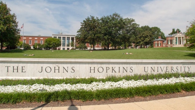 Close-up of sign reading The Johns Hopkins University with MSE Library and Homewood House museum in the background on the Homewood Campus at the Johns Hopkins University in Baltimore, Maryland, July 16, 2004. From the Homewood Photography collection. (Photo by JHU Sheridan Libraries/Gado/Getty Images)