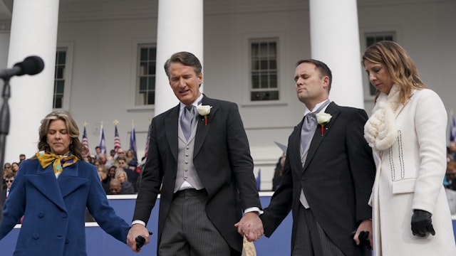 Glenn Youngkin, governor of Virginia, center, holds hands in prayer with Jason Miyares, attorney general of Virginia. Photographer: Al Drago/Bloomberg