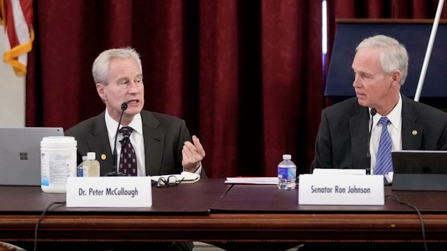 WASHINGTON, DC - JANUARY 24: (L-R) Dr. Peter McCullough speaks as Sen. Ron Johnson (R-WI) looks on during a panel discussion titled COVID 19: A Second Opinion in the Kennedy Caucus Room of the Russell Senate Office Building on Capitol Hill on January 24, 2022 in Washington, DC. The panel featured scientists and doctors who have been criticized for expressing skepticism about COVID-19 vaccines and for promoting the use of unproven medications for treatment of the disease. (Photo by Drew Angerer/Getty Images)