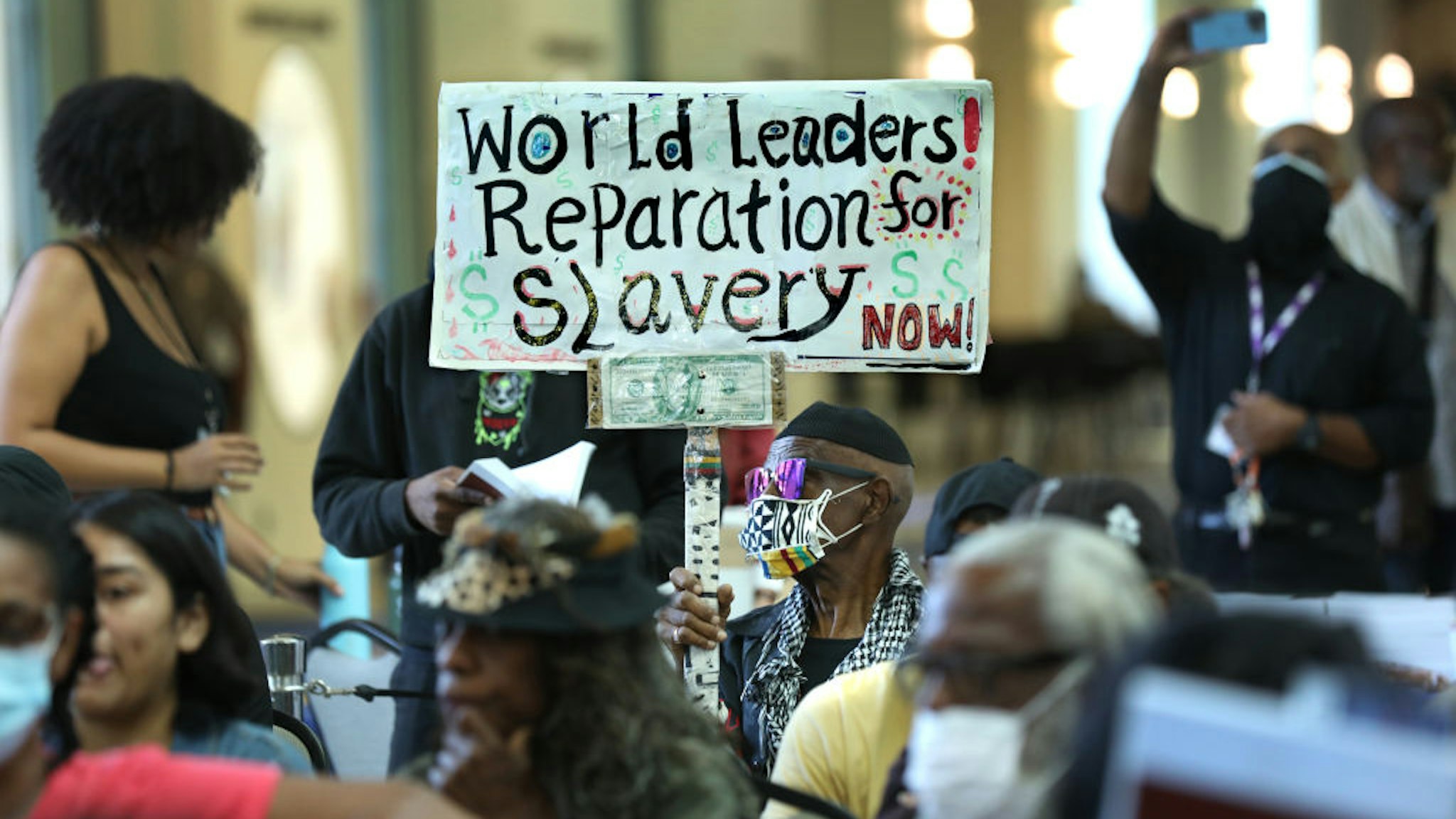 Los Angeles, CaliforniaSept. 22, 2022Los Angeles long-time resident, Walter Foster, age 80, holds up a sign as the Reparations Task Force meets to hear public input on reparations at the California Science Center in Los Angeles on Sept. 22, 2022. (Carolyn Cole / Los Angeles Times via Getty Images)