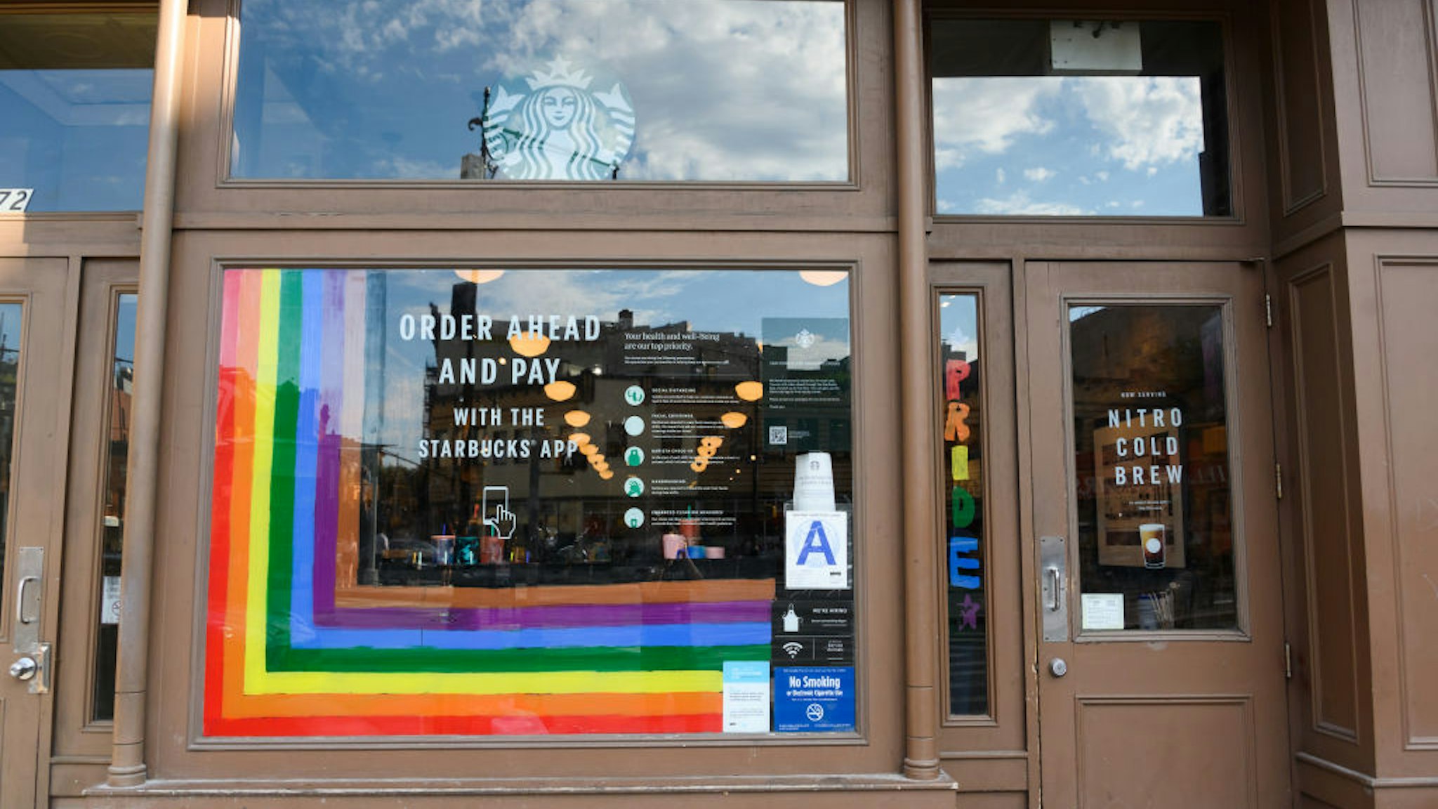 NEW YORK, NEW YORK - JUNE 26: Rainbow art is seen outside Starbucks in the West Village on June 26, 2020 in New York City. Due to the ongoing Coronavirus pandemic, this year's pride march had to be canceled over health concerns. The annual event, which sees millions of attendees, marks its 50th anniversary since the first march following the Stonewall Inn riots. (Photo by Noam Galai/Getty Images)