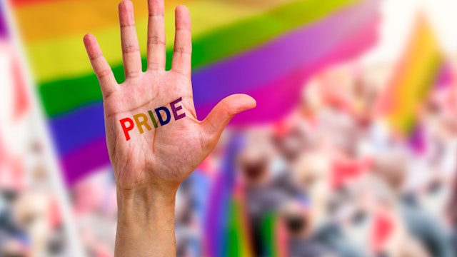 Gay guy's hand with a tattoo that says pride. Symbol of sexual liberation and tolerance