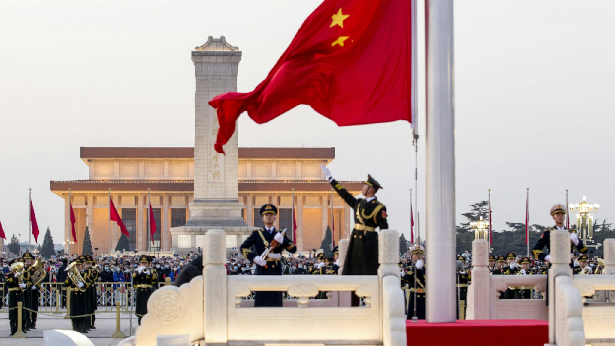 BEIJING, CHINA - JANUARY 01: Soldiers of the People's Liberation Army (PLA) honor guard perform the flag-raising ceremony at Tiananmen Square on New Year's Day on January 1, 2022 in Beijing, China.