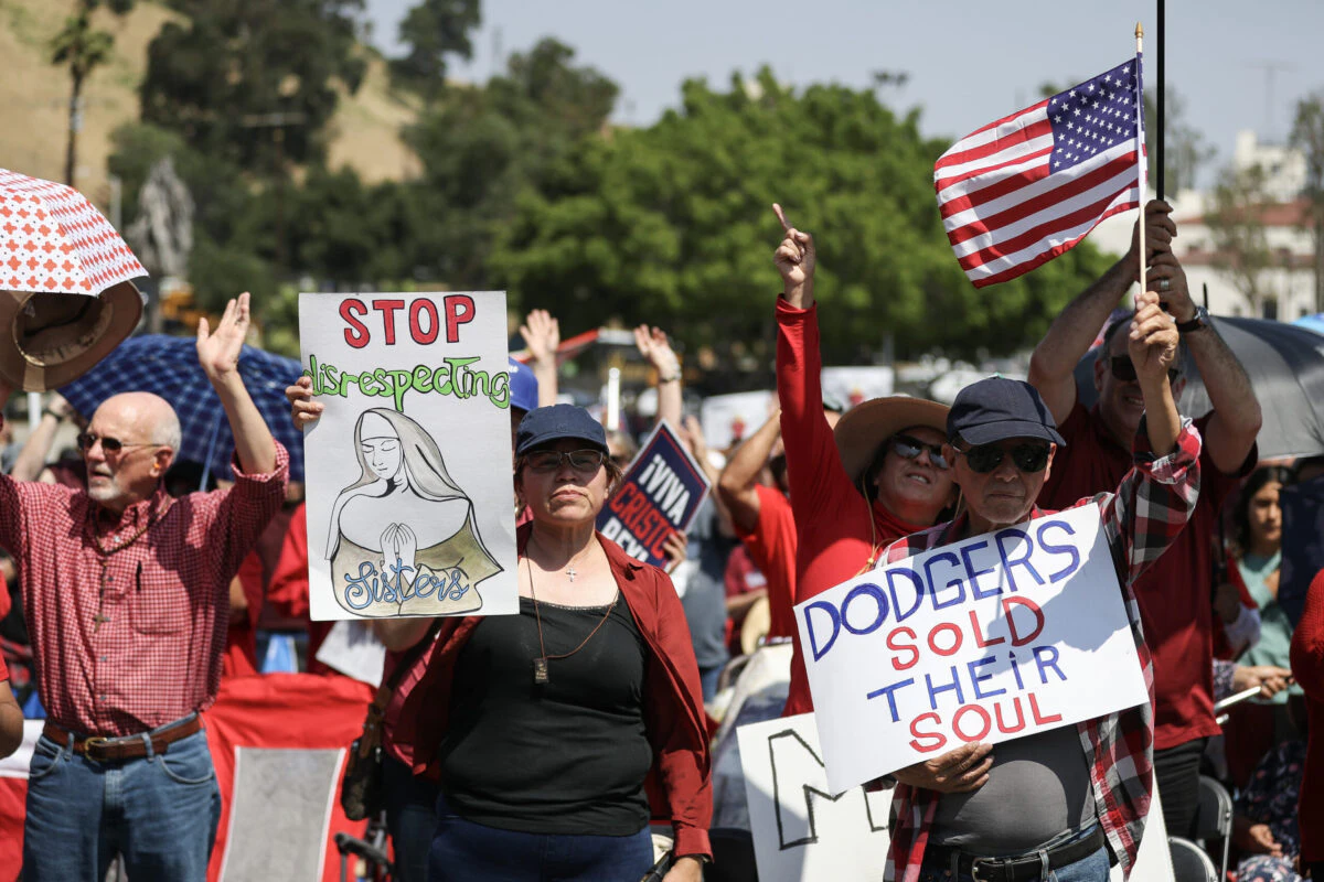 Protesters hold signs at a Catholics for Catholics event in response to the Dodgers' Pride Night event including the Sisters of Perpetual Indulgence, before the game between the Los Angeles Dodgers and the San Francisco Giants at Dodger Stadium on June 16, 2023 in Los Angeles, California.