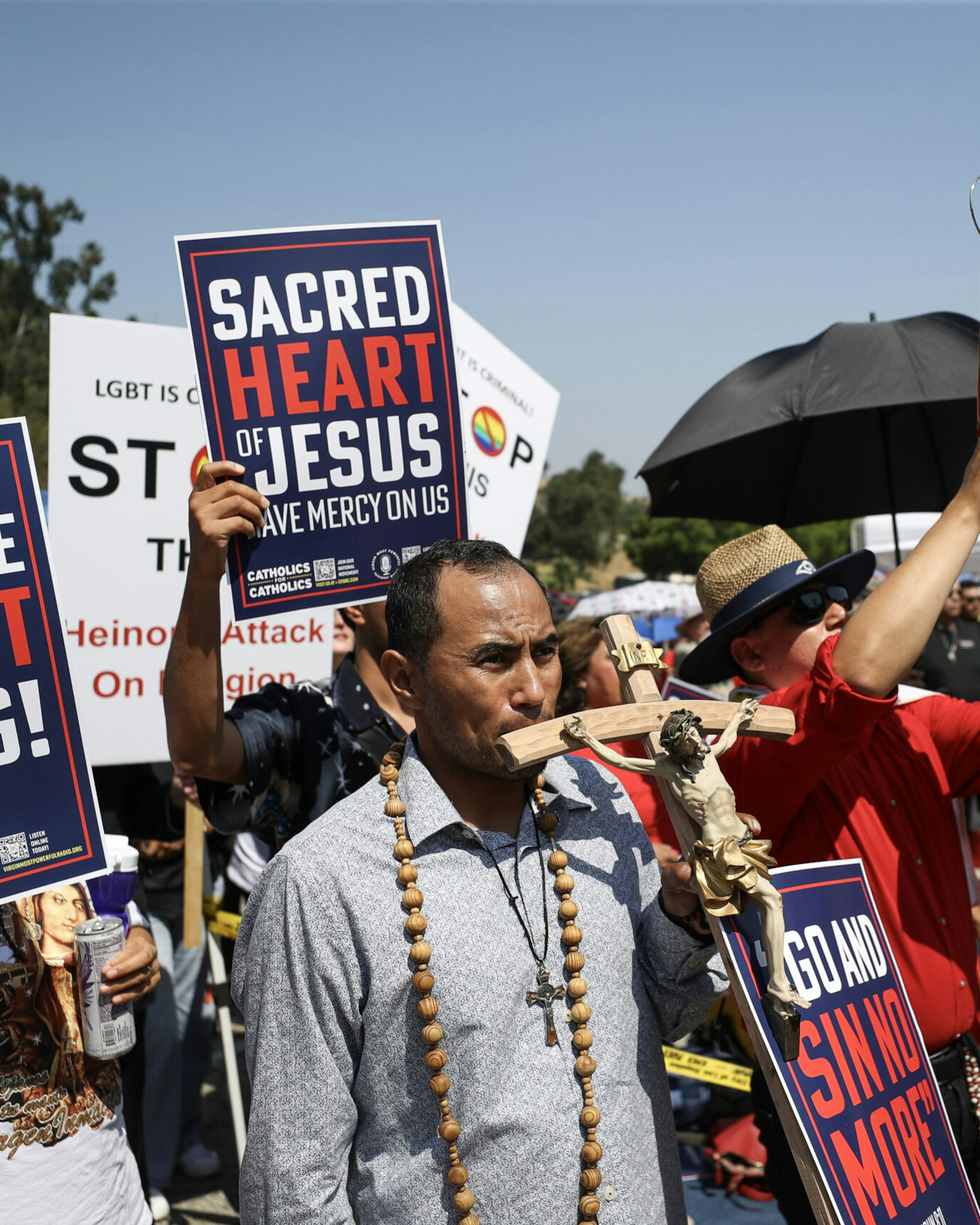 LOS ANGELES, CALIFORNIA - JUNE 16: Protesters hold signs at a Catholics for Catholics event in response to the Dodgers' Pride Night event including the Sisters of Perpetual Indulgence, before the game between the Los Angeles Dodgers and the San Francisco Giants at Dodger Stadium on June 16, 2023 in Los Angeles, California. (Photo by Meg Oliphant/Getty Images)