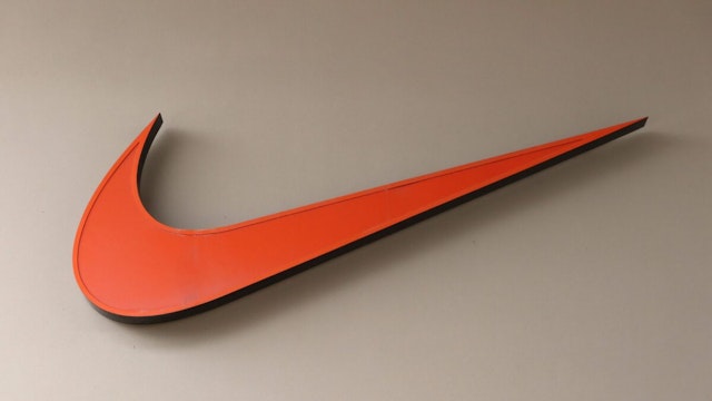 A Nike corporate logo hangs on a wall outside their store at the Toronto Premium Outlets shopping mall on July 1, 2022, in Halton Hills, Ontario.