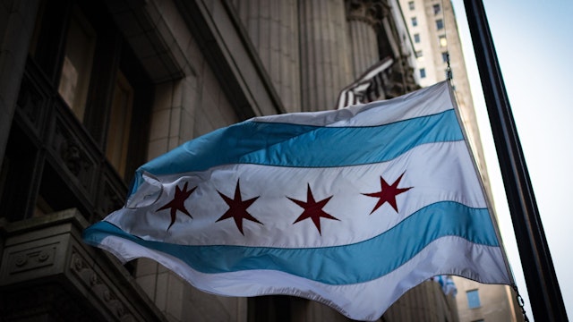 A Chicago flag outside Chicago City Hall flies over LaSalle Street.