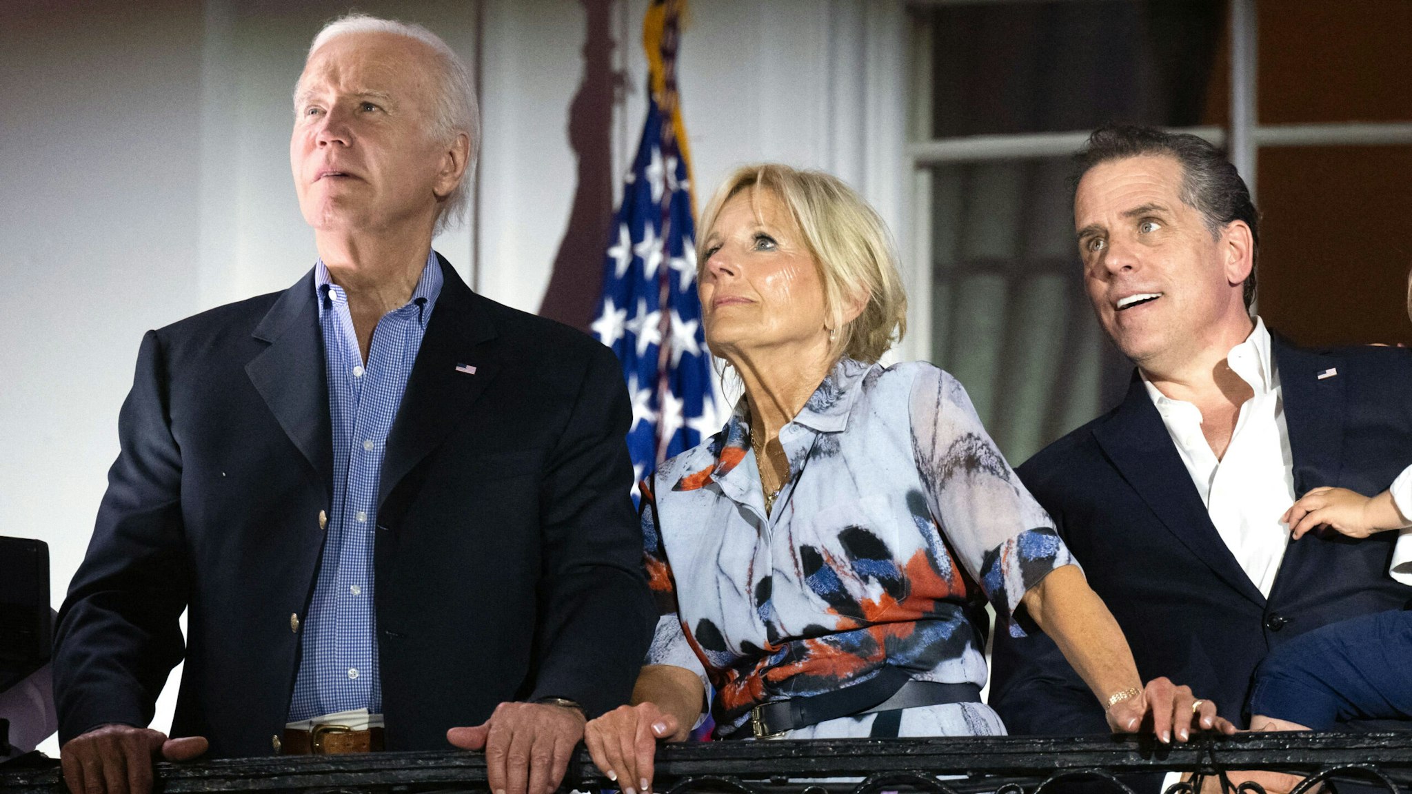 US President Joe Biden, First Lady Jill Biden and Hunter Biden with his son Beau watch the Independence Day fireworks display from the Truman Balcony of the White House in Washington, DC, on July 4, 2023.