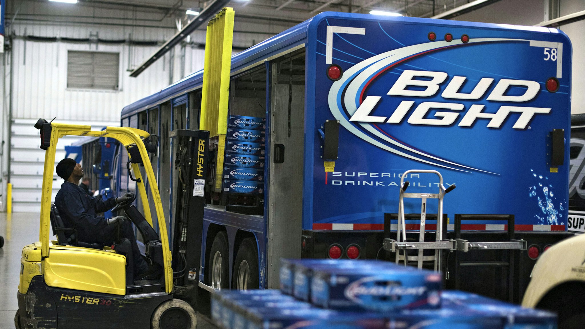 Cases of Anheuser-Busch Bud Light brand beer are loaded into a delivery truck at Brewers Distributing Co. in Peoria, Illinois, U.S., on Thursday, Oct. 30, 2014. Anheuser-Busch Inbev NV is scheduled to report third-quarter earnings on Oct. 31.