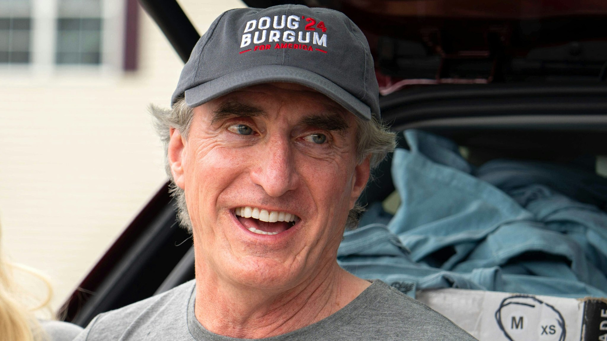 Doug Burgum, governor of North Dakota, right, attends the Independence Day parade in Merrimack, New Hampshire, US, on Tuesday, July 4, 2023. Republican presidential candidates face an early test this month of whether they can raise enough money to sustain their campaigns through party primaries and break away from a growing GOP field.