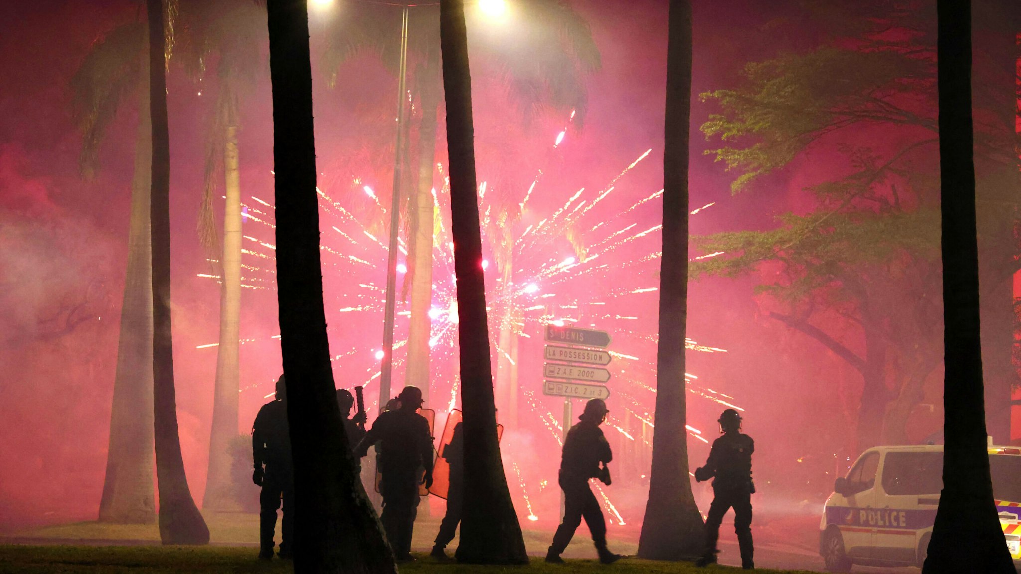 TOPSHOT - Fireworks explode during clashes with police in Le Port, French Indian Ocean island of La Reunion, on June 30, 2023, three days after a 17-year-old boy was shot in the chest by police at point-blank range in Nanterre, a western suburb of Paris. A third consecutive night of violence in France sparked by the killing of a teenager by a policeman during a traffic stop has left 249 police and gendarmes injured, the interior ministry announced on June 30, 2023.