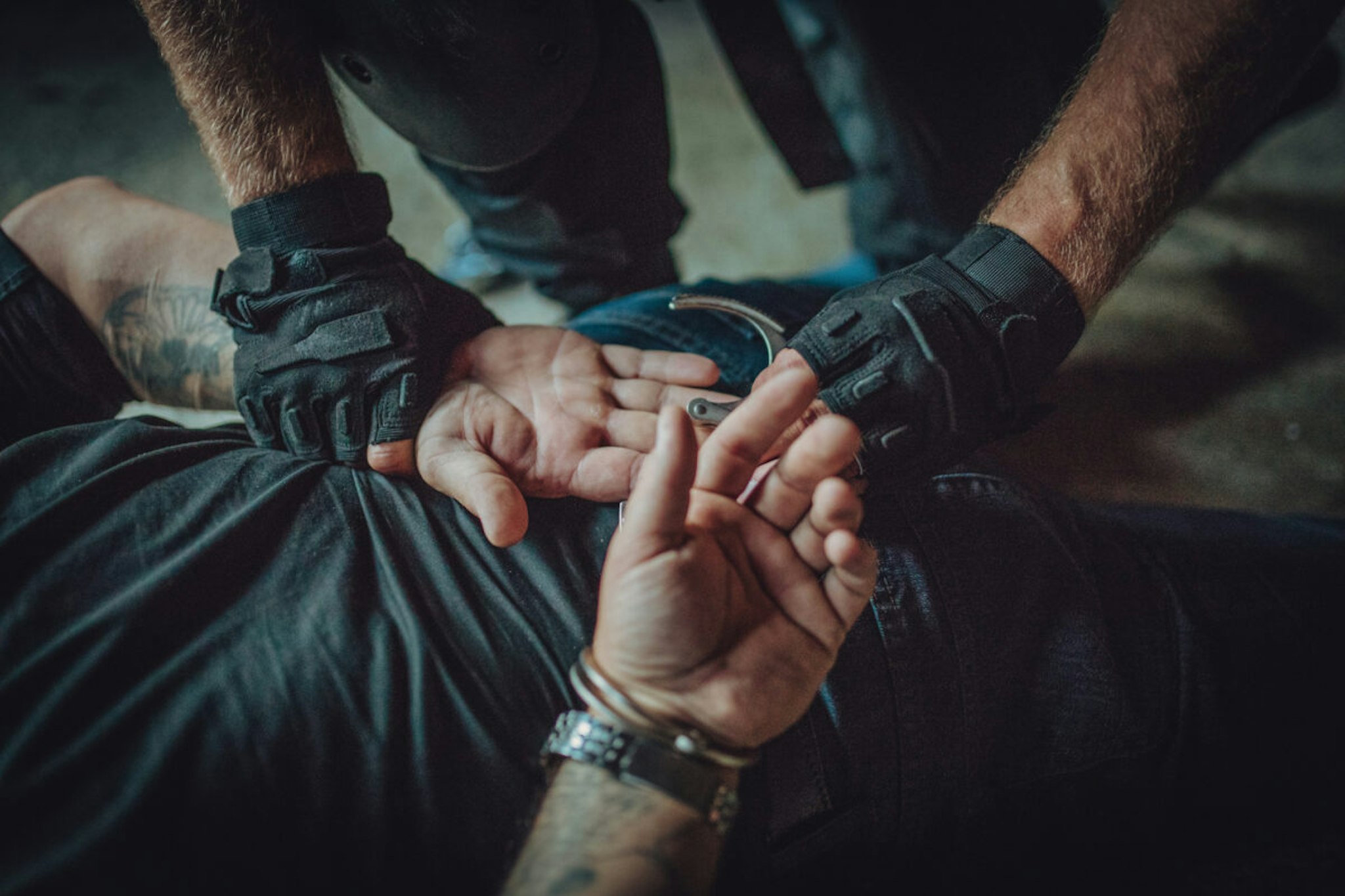 Police putting handcuffs on a man - stock photo