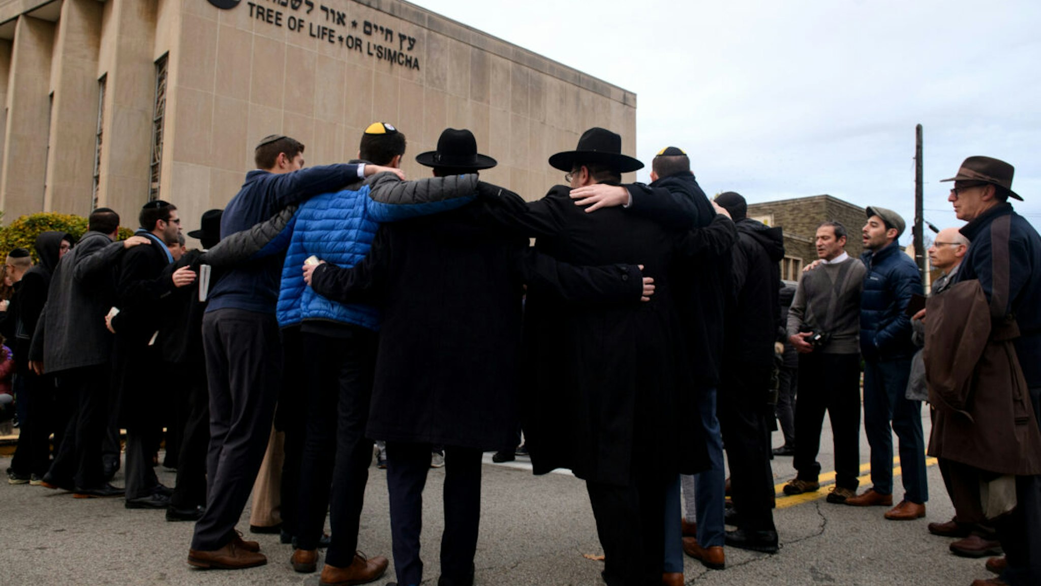 PITTSBURGH, PA - NOV 2: Members of the Jewish faith gather in front of the Tree of Life Synagogue for the Shabbat on Friday evening, November 2, 2018 in Pittsburgh's Squirrel Hill neighborhood. 11 people were killed in a mass shooting at the synagogue on Saturday morning. Six others were injured as well including four police officers who responded to the incident.