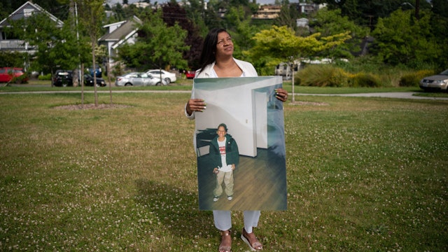 SEATTLE, WA - JULY 02: Donnitta Sinclair-Martin, mother of Horace Lorenzo Anderson, poses with a portrait of her son from about ten years ago during a memorial and rally for peace in memory of Anderson on July 2, 2020 in Seattle, Washington. Anderson, who was 19-years-old, was shot and killed just outside of the Capitol Hill Organized Protest (CHOP) zone in Seattle on June 20.
