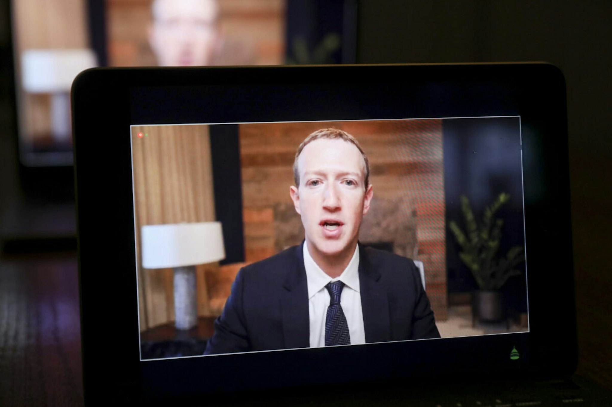 Meta CEO Mark Zuckerberg speaks virtually during a House Energy and Commerce Subcommittees hearing on a laptop computer in Tiskilwa, Illinois, U.S., on Thursday, March 25, 2021.