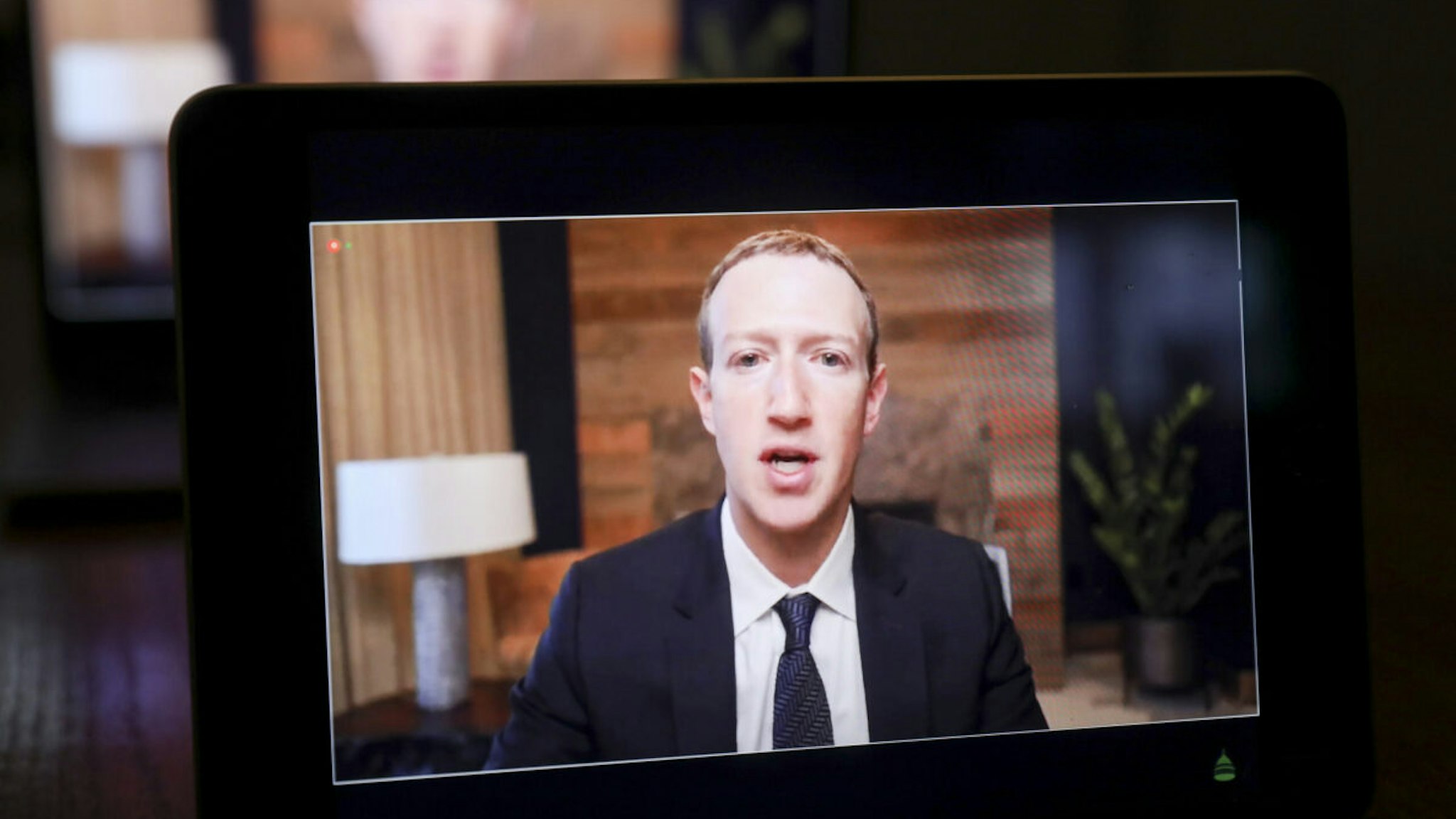 Meta CEO Mark Zuckerberg speaks virtually during a House Energy and Commerce Subcommittees hearing on a laptop computer in Tiskilwa, Illinois, U.S., on Thursday, March 25, 2021.