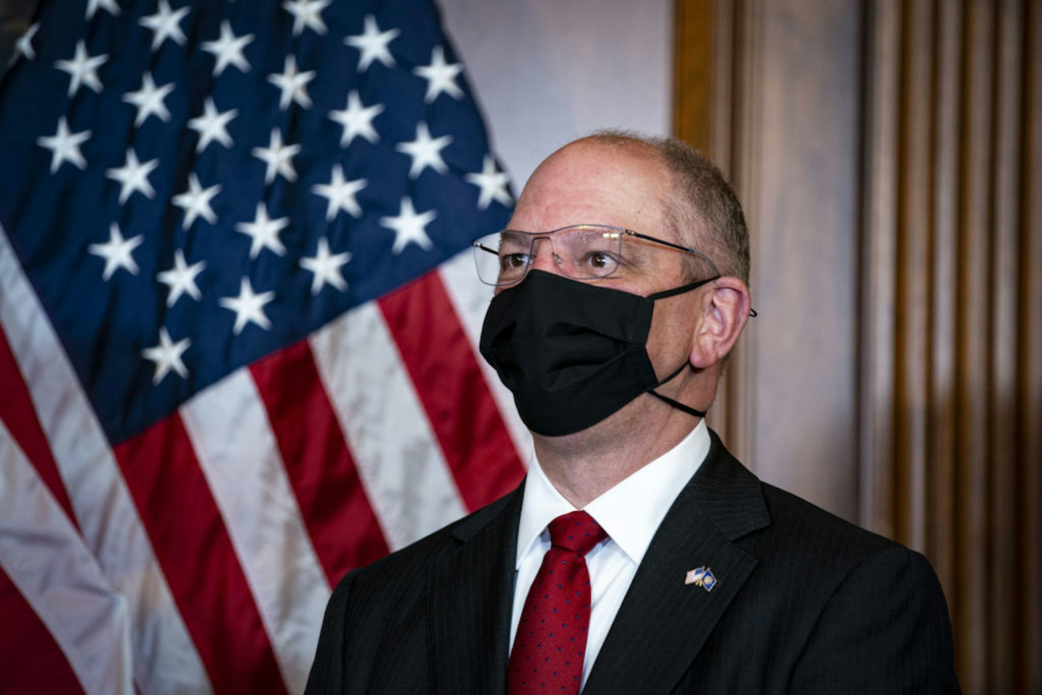 John Bel Edwards, governor of Louisiana, wears a protective mask as he participates in the mock swearing-in ceremony for Representative-elect Troy Carter, a Democrat from Louisiana, not pictured, in the Rayburn Room in the U.S. Capitol in Washington, D.C., U.S., on Tuesday, May 11, 2021. Lawmakers face an uncertain path forward on a debt limit fix, as experts offer differing projections of how soon they'll have to raise or suspend the ceiling to avoid a default on payments.