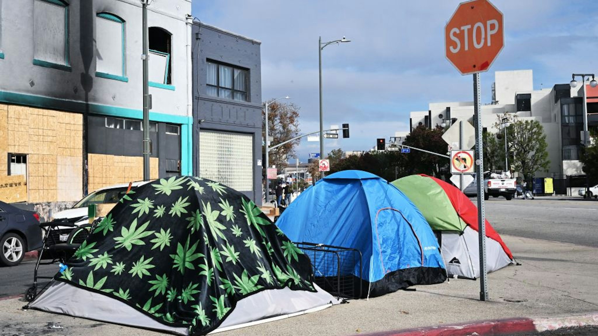 Tents for the homeless line a street corner in Los Angeles, California, on December 6, 2022. - A state of emergency over spiralling levels of homelessness was declared in Los Angeles December 12,2022 as the new mayor Karen Bass pledged a "seismic shift" for America's second biggest city. Tens of thousands of people sleep rough on Los Angeles' streets, in an epidemic that shocks many visitors to one of the wealthiest urban areas on the planet. Mayor Karen Bass, who was sworn into office Sunday, used her first full day in office to declare a state of emergency. (Photo by Frederic J. BROWN / AFP) (Photo by FREDERIC J. BROWN/AFP via Getty Images)