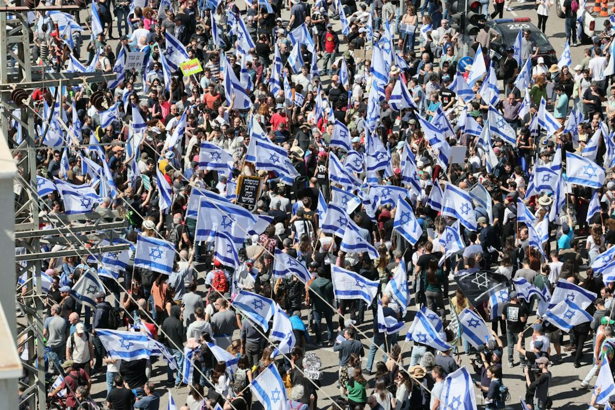 Israelis wave national flags as they protest against the government's controversial judicial reform bill in Tel Aviv on March 9, 2023. (Photo by JACK GUEZ / AFP)