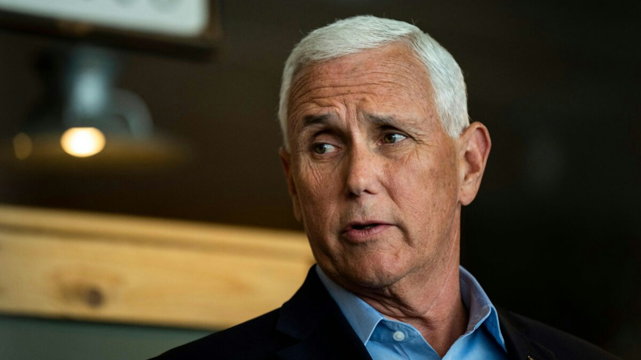 Former US Vice President Mike Pence speaks with members of the media during a campaign event at a Pizza Ranch restaurant in Waukee, Iowa on June 8, 2023.