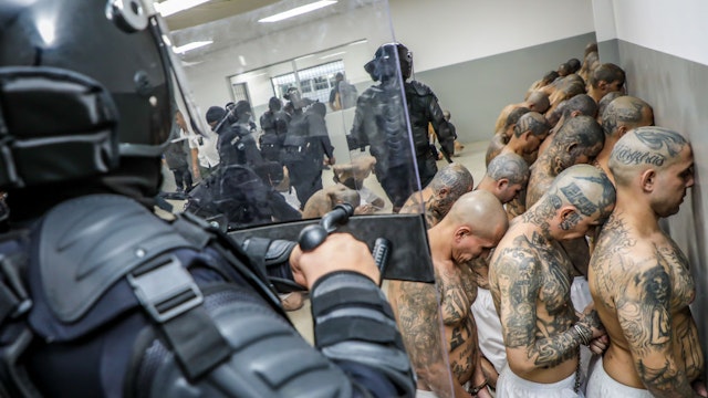 TECOLUCA, EL SALVADOR - FEBRUARY 24: A first group of 2,000 detainees are moved to the mega- prison Terrorist Confinement Centre (CECOT) on February 24, 2023 in Tecoluca, El Salvador. Since president Nayib Bukele announced state of exception in March 2022, over 62,000 suspected gang members have been arrested. Human Rights organizations denounce abuses and due process violations. El Salvador has one of highest crime rates in Latin America. (Photo by Presidencia El Salvador via Getty Images )