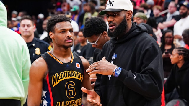 HOUSTON, TEXAS - MARCH 28: Bronny James #6 of the West team talks to Lebron James of the Los Angeles Lakers after the 2023 McDonald's High School Boys All-American Game at Toyota Center on March 28, 2023 in Houston, Texas.