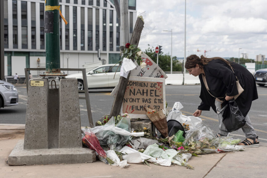NANTERRE, FRANCE - JULY 1: A woman pays her respects at the site where Nahel M. died, shortly after his funeral, on July 1, 2023 in Nanterre, France. Nahel M., a French teenager of North African origin was shot dead by police on June 27th, the third fatal traffic stop shooting this year in France - causing nationwide unrest and clashes with police forces. (Photo by Sam Tarling/Getty Images)