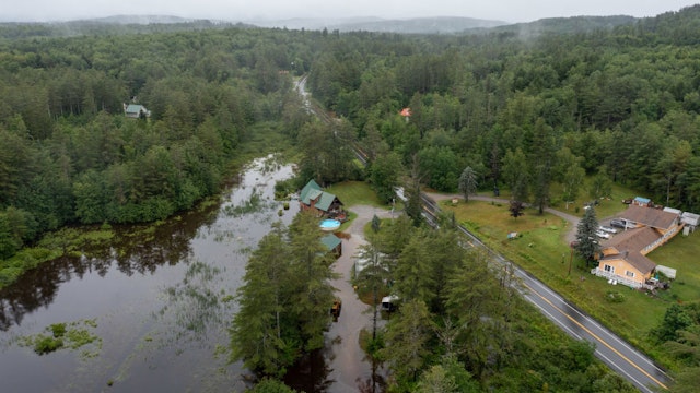 LONDONDERRY, VERMONT - JULY 10: In an aerial view, water covers residential property on Route 11 after heavy rain on July 10, 2023 in Londonderry, Vermont. Torrential rain and flooding has affected millions of people from Vermont south to North Carolina.