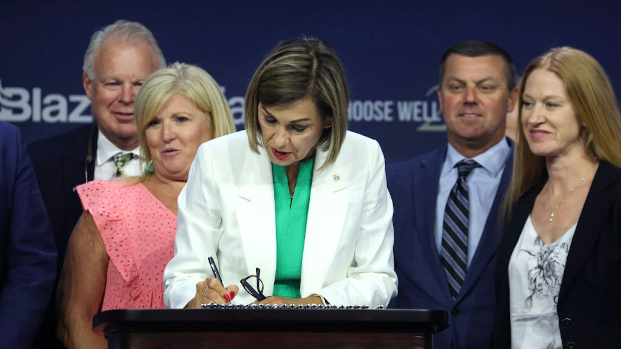 DES MOINES, IOWA - JULY 14: Iowa Governor Kim Reynolds signs into law a bill that will ban most abortions after around six weeks of pregnancy during a visit to the Family Leadership Summit on July 14, 2023 in Des Moines, Iowa. Several Republican presidential candidates were scheduled to speak at the event, billed as “The Midwest’s largest gathering of Christians seeking cultural transformation in the family, Church, government, and more.” (Photo by Scott Olson/Getty Images)