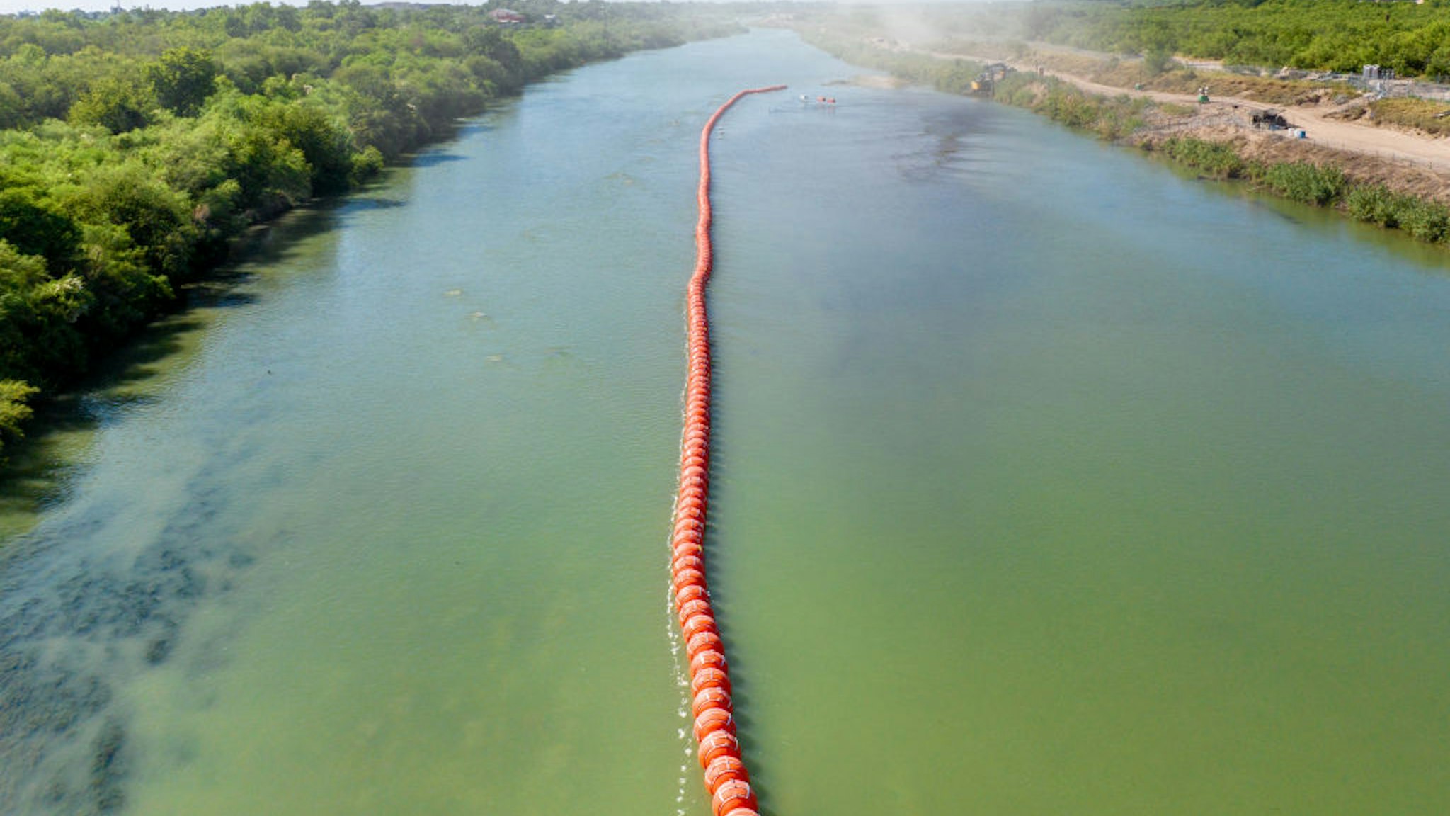 EAGLE PASS, TEXAS - JULY 18: Buoy barriers are installed and situated in the middle of the Rio Grande river on July 18, 2023 in Eagle Pass, Texas. Texas has begun installing buoy barriers along portions of the Rio Grande river in an effort to deter illegal border crossings.