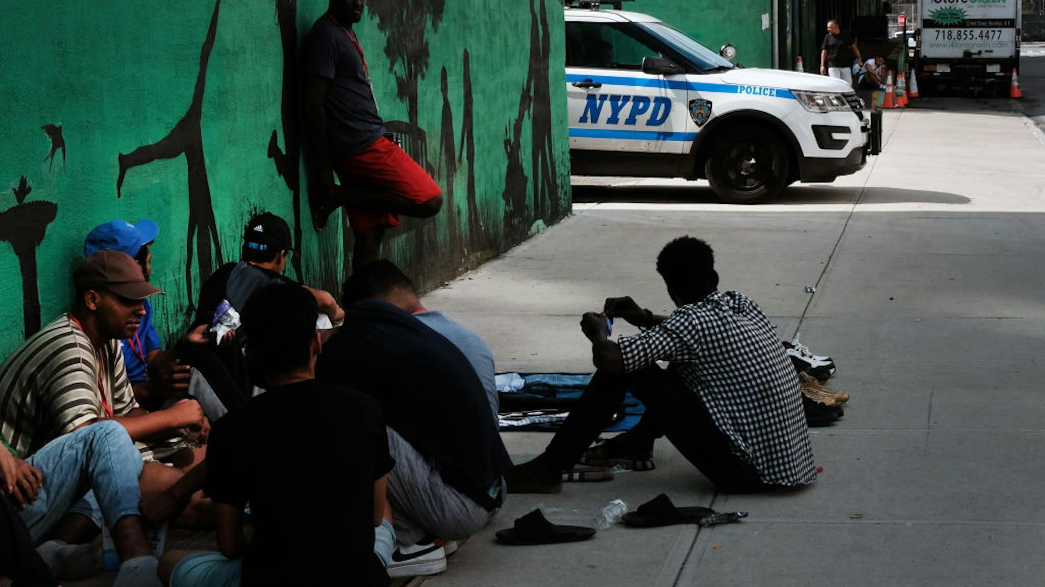 New York City Removes Migrant Tent Encampment In Brooklyn NEW YORK, NEW YORK - JULY 21: Police patrol outside of a migrant shelter in Brooklyn on July 21, 2023 in New York City. The new shelter is being called the largest dormitory-style shelter in the history of New York City and is near the Brooklyn Navy Yard in the Clinton Hill section of Brooklyn. New York City is struggling with housing and feeding the approximately 90,000 migrants who have arrived in the city since April 2022. (Photo by Spencer Platt/Getty Images)