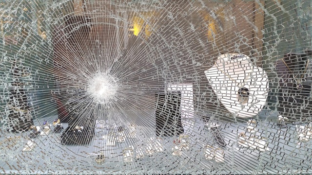 Broken window in jeweler's shop after raid