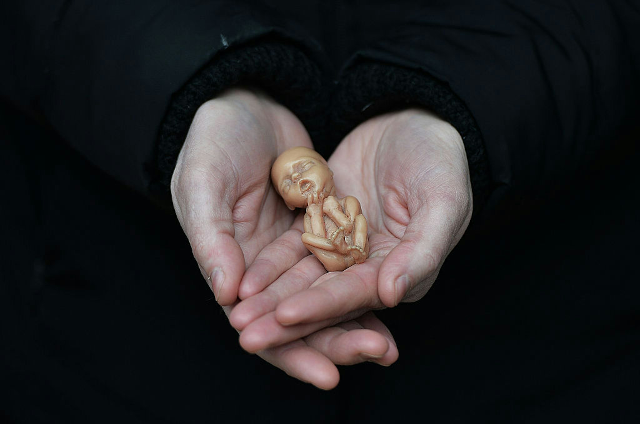 BELFAST, NORTHERN IRELAND - APRIL 07: A Pro Life campaigner displays a plastic doll representing a 12 week old foetus as she stands outside the Marie Stopes Clinic on April 7, 2016 in Belfast, Northern Ireland. The anit abortion supporters have protested outside the clinic where women can go for advice concerning terminating their pregnancy since it opened in 2012. The abortion laws in Northern Ireland are in the news again after a 21 year old Northern Irish woman was convicted and sentenced earlier this week for procuring a miscarriage. The woman who cannot be named for legal reasons had pleaded guilty to two charges of procuring her own abortion by using a poison and of supplying a poison with intent to procure a miscarriage, she was ten-twelve weeks pregnant at the time. She was given a three-month prison sentence by Judge David McFarland at Belfast high court, which was suspended for two years. Unlike the rest of the United Kingdom, the law in Northern Ireland rules that terminating a pregnancy is illegal except in very limited circumstances. (Photo by Charles McQuillan/Getty Images)