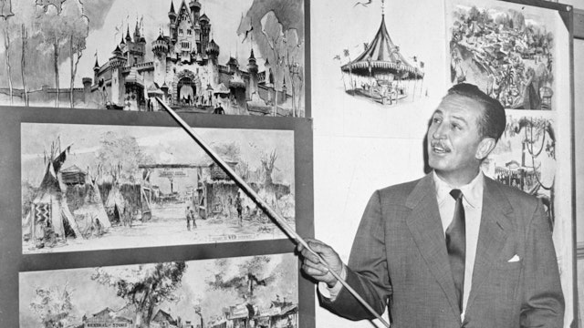 American producer, director, and animator Walt Disney (1901 - 1966) uses a baton to point to sketches of Disneyland, 1955. (Photo by Hulton Archive/Getty Images)