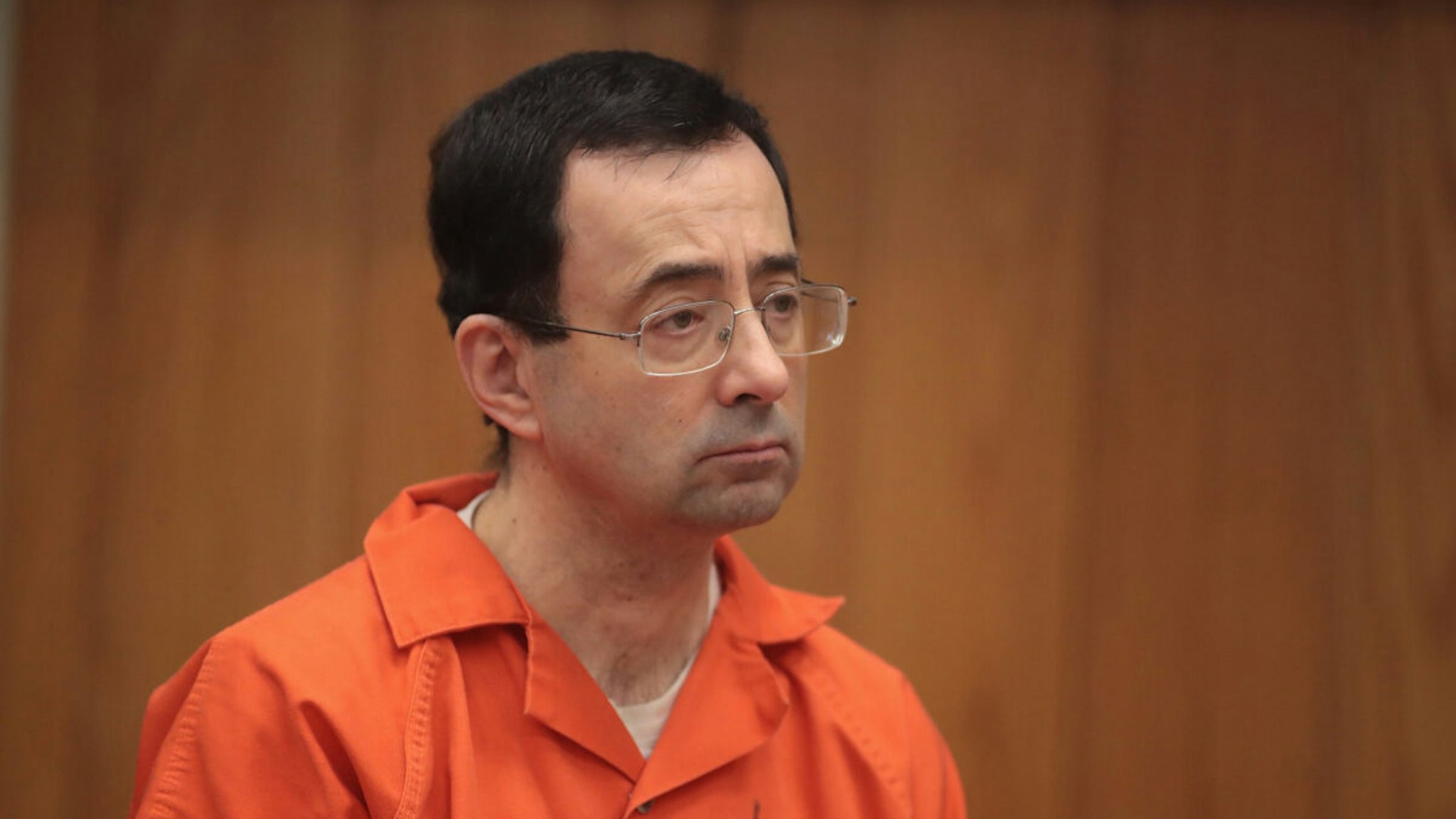 CHARLOTTE, MI - FEBRUARY 05: Larry Nassar stands as he is sentenced by Judge Janice Cunningham for three counts of criminal sexual assault in Eaton County Circuit Court on February 5, 2018 in Charlotte, Michigan. Nassar has been accused of sexually assaulting more than 150 girls and young women while he was a physician for USA Gymnastics and Michigan State University. Cunningham sentenced Nassar to 40 to 125 years in prison. He is currently serving a 60-year sentence in federal prison for possession of child pornography. Last month a judge in Ingham County, Michigan sentenced Nassar to an 40 to 175 years in prison after he plead guilty to sexually assaulting seven girls.