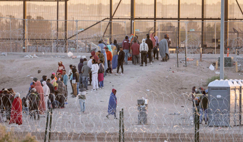 EL PASO, TEXAS - MAY 12: Immigrants wait to be transported and processed by U.S. Border Patrol officers at the U.S.-Mexico border on May 12, 2023 in El Paso, Texas. The U.S. Covid-era Title 42 immigration policy ended the night before, and migrants entering the system now are anxious over how the change may affect their asylum claims. (Photo by John Moore/Getty Images)