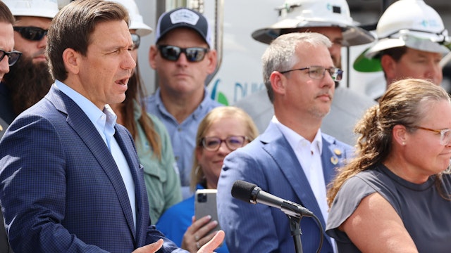 Florida Gov. Ron DeSantis speaks among Duke Energy electrical line technicians during a press conference at Duke Energy's Operations Center in Wildwood, Florida on Tuesday, Aug. 29, 2023. Duke Energy is staging thousands of workers and trucks nearby in Summerville in preparation for the arrival of Hurricane Idalia.