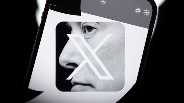 An effigy of Elon Musk is seen on a mobile device with the X and Twitter logos in this photo illustration on 23 July, 2023 in Warsaw, Poland.