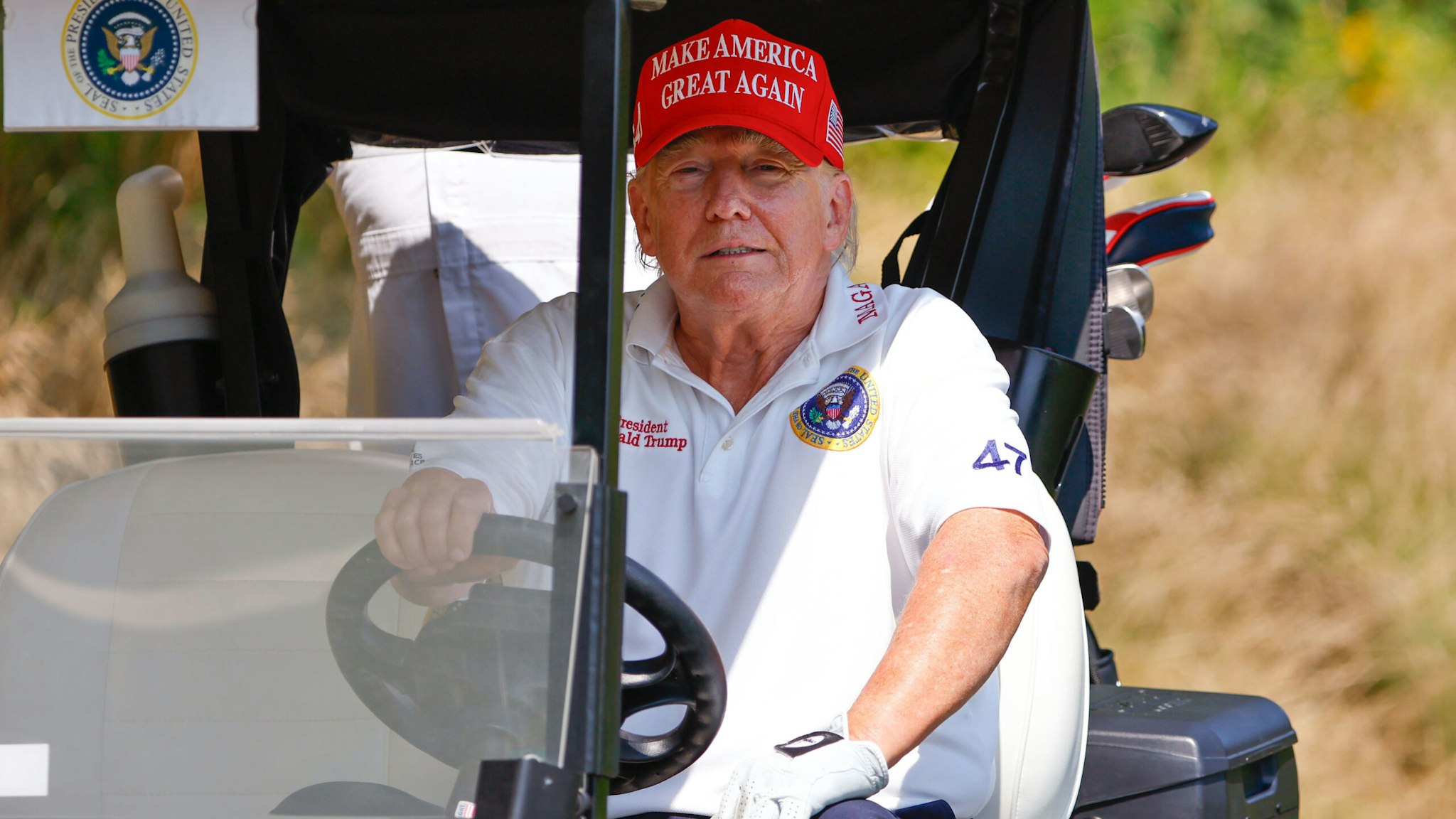 BEDMINSTER, NJ - AUGUST 09: Former President Donald Trump in his cart going to the 14th green during a practice round at Trump National Golf Club on August 9, 2023 in Bedminster, New Jersey