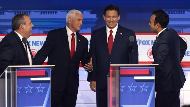 MILWAUKEE, WISCONSIN - AUGUST 23: Republican presidential candidates (L-R), former New Jersey Gov. Chris Christie, former U.S. Vice President Mike Pence, Florida Gov. Ron DeSantis and Vivek Ramaswamy speak during a break in the first debate of the GOP primary season hosted by FOX News at the Fiserv Forum on August 23, 2023 in Milwaukee, Wisconsin. Eight presidential hopefuls squared off in the first Republican debate as former U.S. President Donald Trump, currently facing indictments in four locations, declined to participate in the event.
