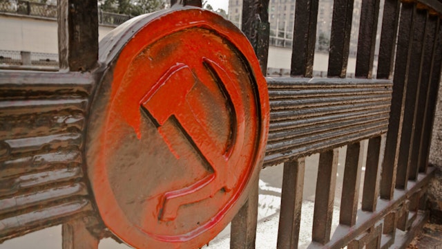 A railing in the centre of Moscow has the famous hammer and sickle engraved into it. A red hammer and sickle, in the shape it appeared (in gold) on the Soviet Union's flag from 1955 to 1991Moscow, Russia.