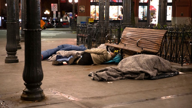 SEATTLE, WA - APRIL 06: People sleep outside on a sidewalk on April 6, 2020 in Seattle, Washington. The City of Seattle and King County are in the process of minimizing the concentration of people living in shelters in response to the coronavirus (COVID-19) outbreak, particularly for people experiencing homelessness and those who cannot safely quarantine in their own homes. They're temporarily adding over a thousand beds in other places and increasing the distance of all beds between people. (Photo by Karen Ducey/Getty Images)